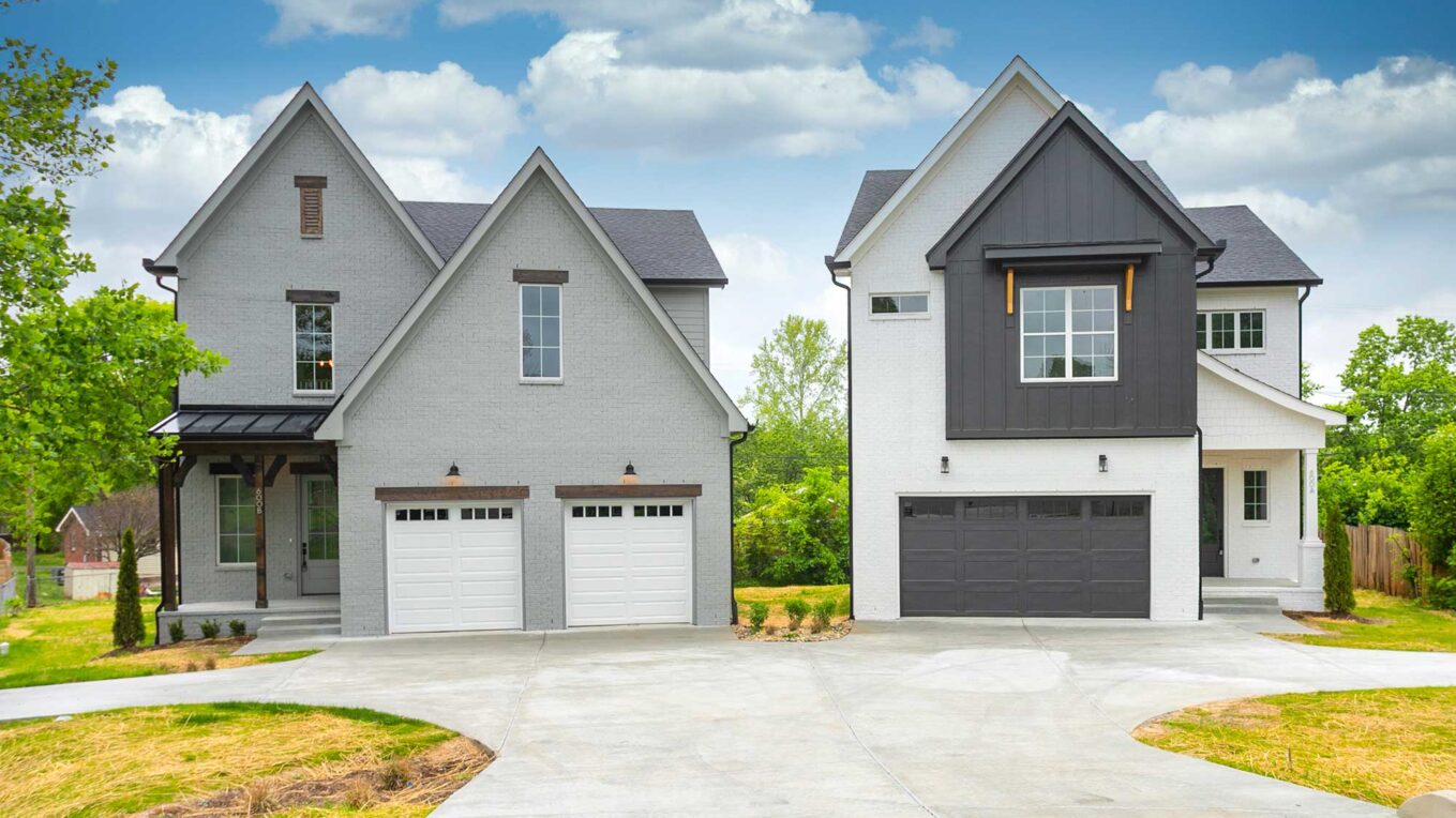 Two houses next to each other with one driveway.